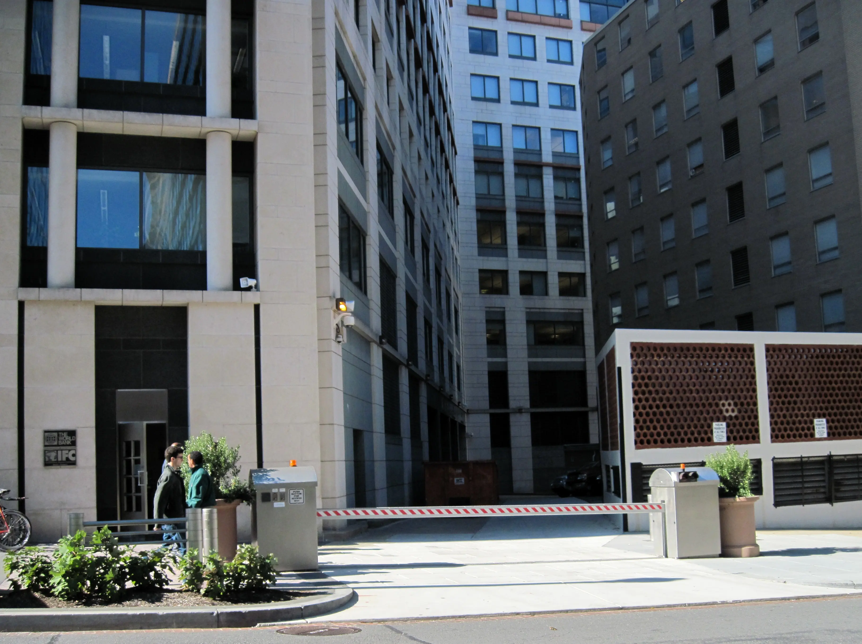 Security gate with striped arm installed at the entrance of "The World Bank" building driveway.